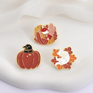 Autumn enamel pins set featuring a fox, crow in pumpkin, and cat among maple leaves