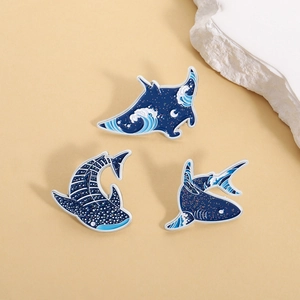 Three-piece set of ocean-themed shark and ray pins with blue wave enamel designs