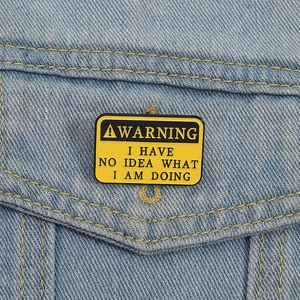 Warning pin with text I Have No Idea What I Am Doing on a denim jacket pocket