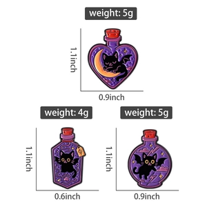 Detailed view of three black cat magic potion enamel pins with bat wings and moon motifs