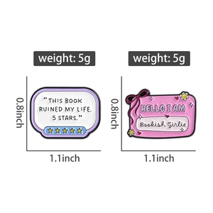 Detailed macro view of bookworm enamel pins with pink bow and funny bookish quotes