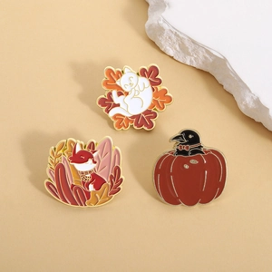 Enamel pins set featuring autumn theme cat on maple leaf, fox in plants and crow in pumpkin