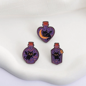 Detailed view of three purple Halloween enamel pins featuring magic potion bat cats