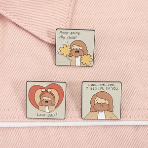 Detail of square enamel pins with inspirational quotes and cartoon Jesus illustrations