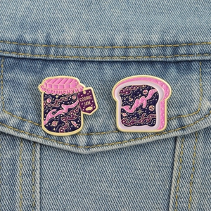 Cosmic jam and toast enamel pin set featuring purple star galaxy design on blue denim jacket