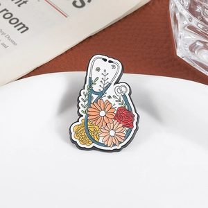 Enamel stethoscope brooch with floral daisy design on elegant white plate