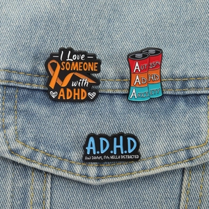 Creative ADHD awareness enamel pins set pinned on denim jacket pocket for accessory display