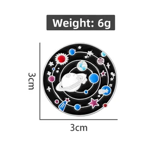 Detail of space galaxy enamel pin with Saturn and astronaut, 3cm diameter and 6g weight