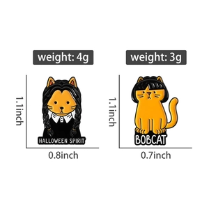 Detail view of cartoon enamel cat pins with Halloween Spirit and Bobcat text designs