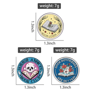 Three enamel book brooches showing dimensions of 1.3 inches and 7g weight for each pin