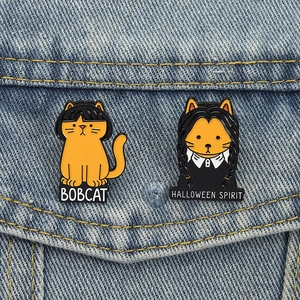 Halloween cartoon orange cat enamel pins with Bobcat and Wednesday spirit on denim