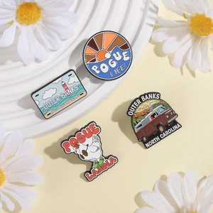 Set of four vintage cartoon metal badges featuring Outer Banks themed bus and sunset designs
