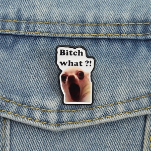 Funny Chihuahua enamel pin with Bitch what?! slogan on light blue denim fabric texture