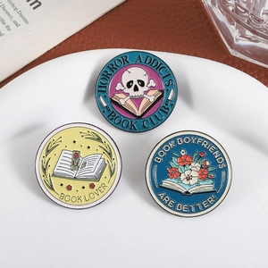Enamel book lover pin set with Horror Addicts and Book Boyfriend designs on white plate