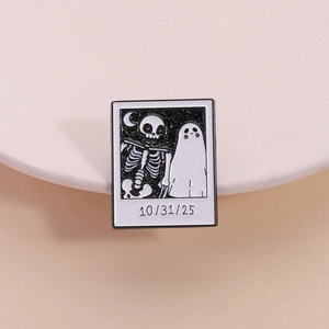 Halloween enamel pin featuring skull and ghost on starry polaroid photo badge