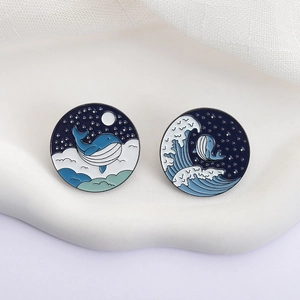 Japanese style blue whale enamel pin badges featuring starry night sky and ocean wave designs