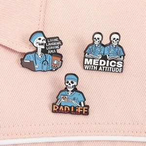 Detailed trio of skull doctor enamel pins with stethoscope on pink textured fabric