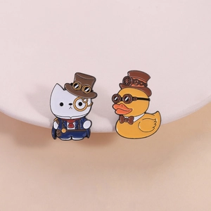 Steampunk enamel pins featuring a cat in top hat and rubber duck with vintage goggles