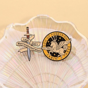 Son of Poseidon enamel pins featuring Pegasus and sword on a pearl glass tray