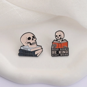 Skull book theme enamel pin set with motivational quotes on a white textured ceramic plate