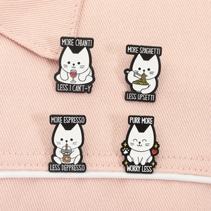 Detail of four cute cat enamel pins featuring funny puns on pink denim background