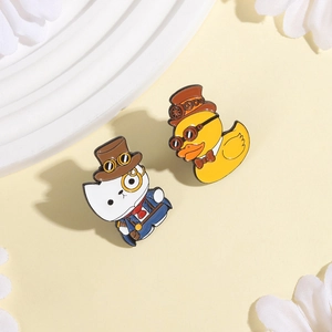 Steampunk enamel brooches featuring a dapper white cat and yellow duck with vintage hats