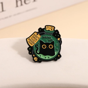 Dark magic black cat potion bottle enamel pin with Drink Me text and green liquid