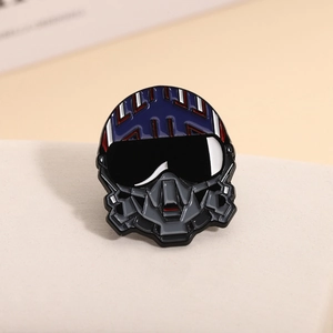 Macro detail of enamel pilot helmet brooch with red, white and blue fighter jet patterns