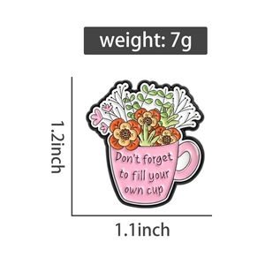 Detail view of pink flower cup enamel pin with Don't forget to fill your own cup text