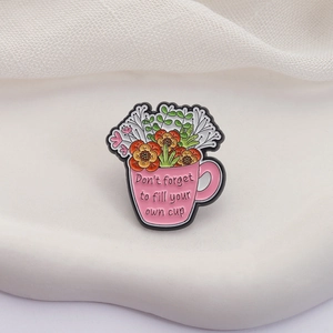 Detailed close-up of pink flower cup enamel pin with motivational English quote