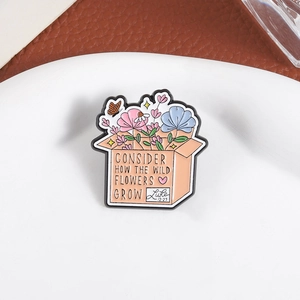 Macro view of enamel flower box brooch with butterfly and Bible quote Luke 12:27