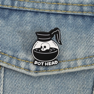 Creative enamel pin featuring a skull coffee pot with Pot Head text on denim jacket