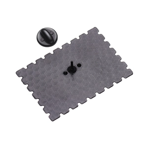Black enamel stamp pin badge with wave edges and honeycomb texture on the back