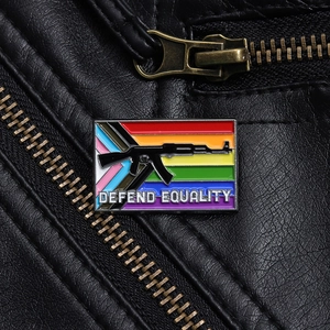 Close-up of Defend Equality rainbow enamel badge pinned on a black leather jacket