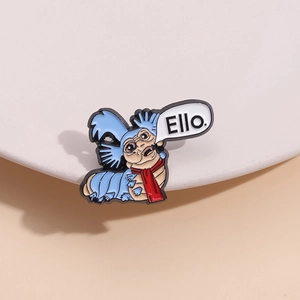 Labyrinth The Worm metal enamel pin with Ello speech bubble on white plate