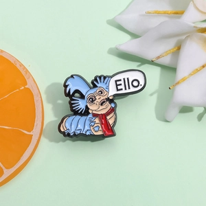 Cartoon caterpillar enamel pin with red scarf and Ello speech bubble on green background