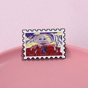 Stamp-shaped enamel pin featuring The Boiling Isles landscape on a pink display tray