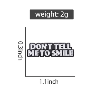 Detail view of rectangular slogan enamel pin with weight and size measurements in inches