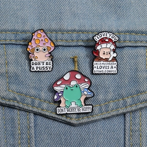 Funny frog and mushroom enamel pins set pinned on a denim jacket for animal lovers