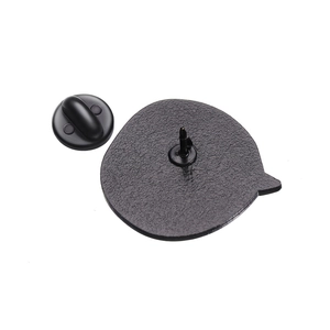 Detail of metal pin back with matte texture and black rubber clutch attachment