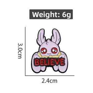 Detail showing a purple rabbit enamel pin with red eyes and BELIEVE sign, 3.0cm size