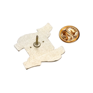 Detailed macro view of the metal brooch back featuring a sharp pin and golden butterfly clutch