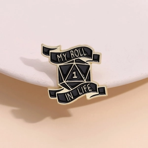 Macro shot of Gothic enamel pin featuring black and gold D20 dice with MY ROLL text