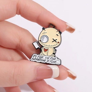 Cartoon enamel pin with a dark humor doll holding a knife on a clean white background