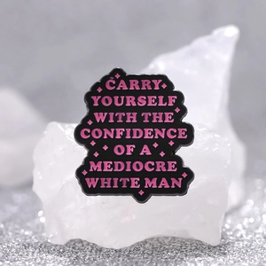 Humorous enamel pin featuring pink text on black metal with sparkling star details