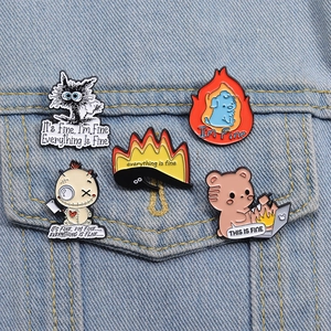 Close-up of funny enamel pins with cat and bear designs on a denim jacket pocket