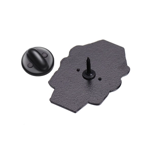 Close-up of black matte metal pin back with secure rubber clutch backing attachment