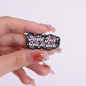 Colorful black cloud enamel pin with Might Just Call In Sick slogan and flower accents