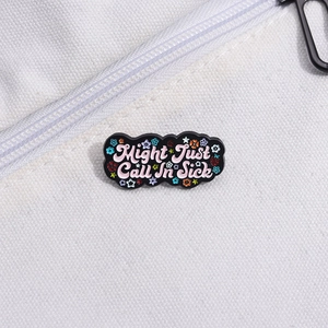 Close-up of Might Just Call In Sick enamel pin with colorful floral details on fabric