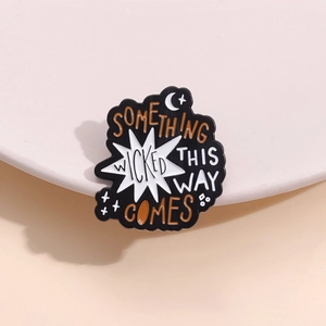 Gothic black enamel brooch with Something Wicked This Way Comes text and crescent moon
